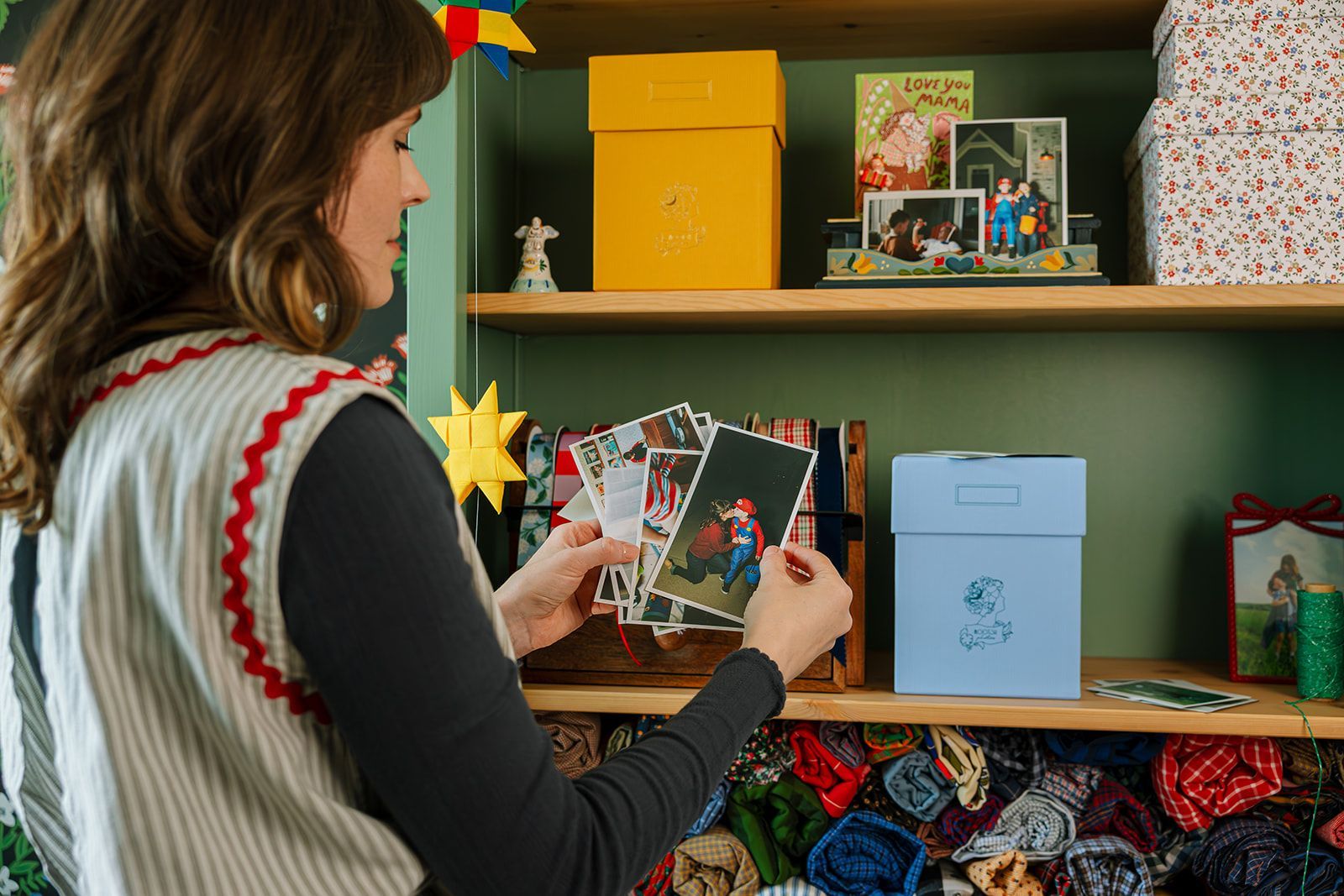 A lady looking at printed photos